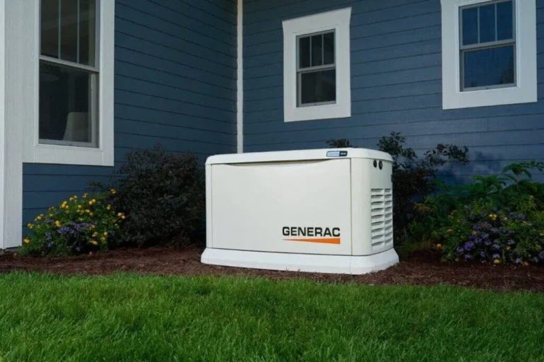 Generator Maintenance | Levine &Amp; Sons Plumbing, Heating, &Amp; Cooling A Generac Standby Generator Is Installed Outside A House With Blue Siding And White Trim, Surrounded By Plants And Grass.
